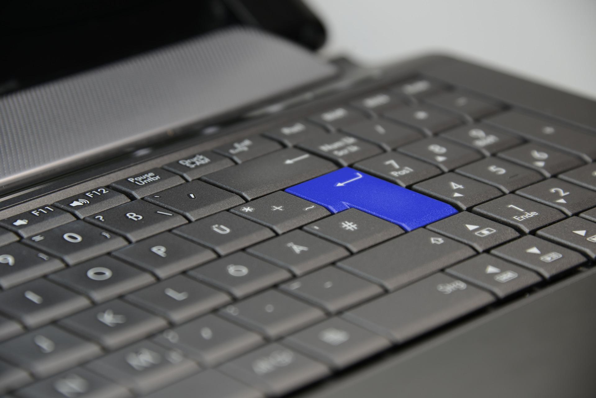 keyboard-453795_1920 Close-up of keyboard with blue enter key.