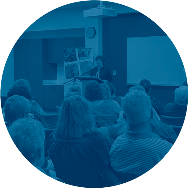 Speaker presents to attentive audience in conference room.