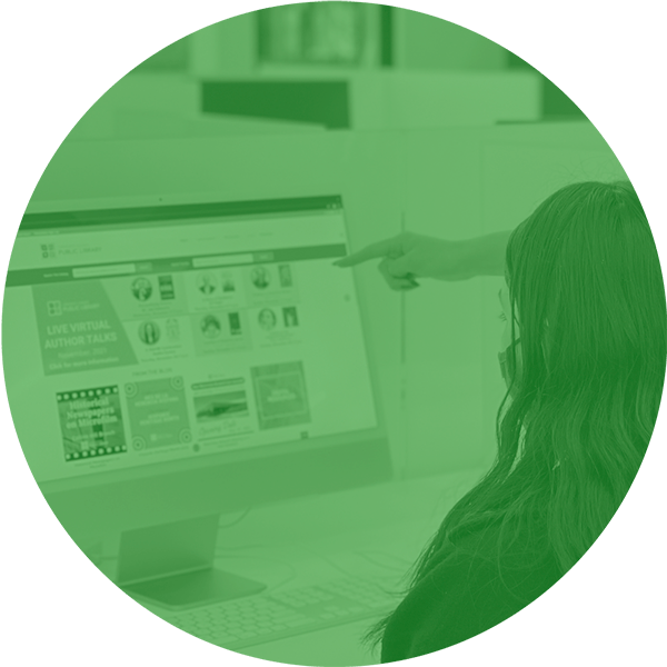 User pointing to library website on computer.
