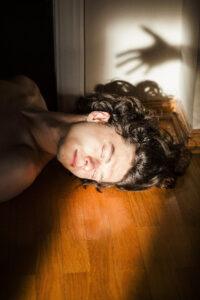 Man's face in sunlight, shadow on wall