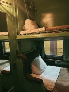 Vintage train sleeper cabin with bunk beds.