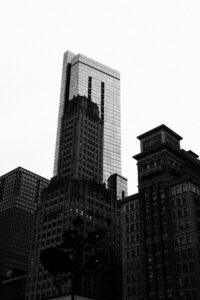 Black and white photo of tall city skyscrapers.