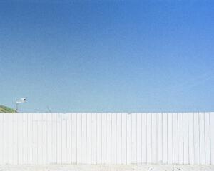 White fence under clear blue sky
