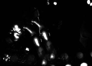 Abstract light reflections on a dark background.