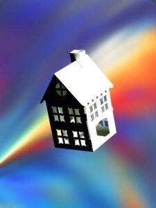 Model house against colorful abstract background.