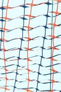 Orange construction net on blue wall