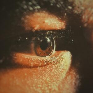 Close-up of a human brown eye with lashes.