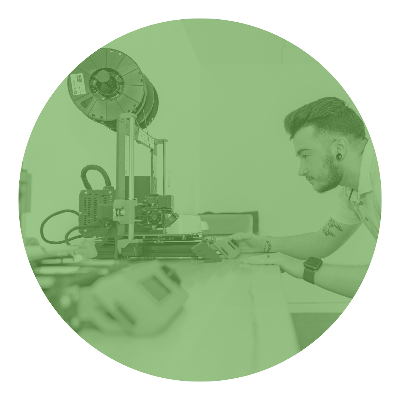 Person using a 3D printer intensely observing process.