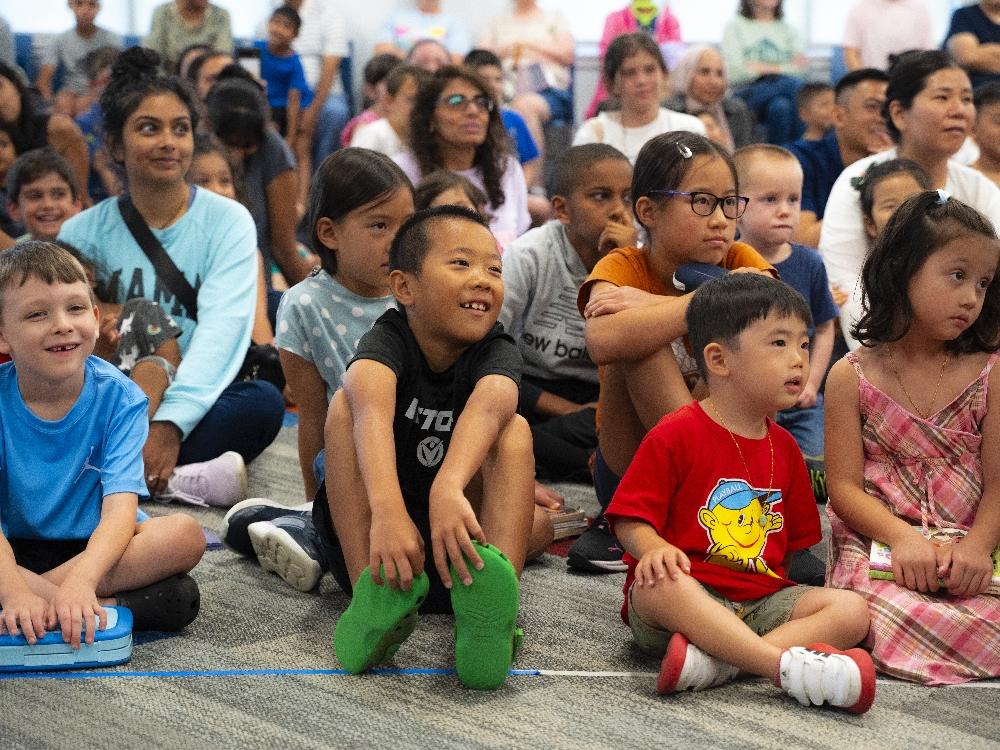 Children sitting at community event.