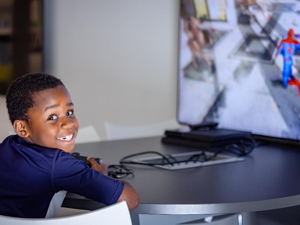 Child smiling while playing video game