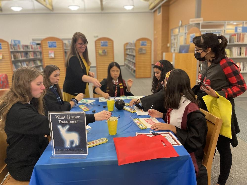 Students in library wearing wizard costumes.