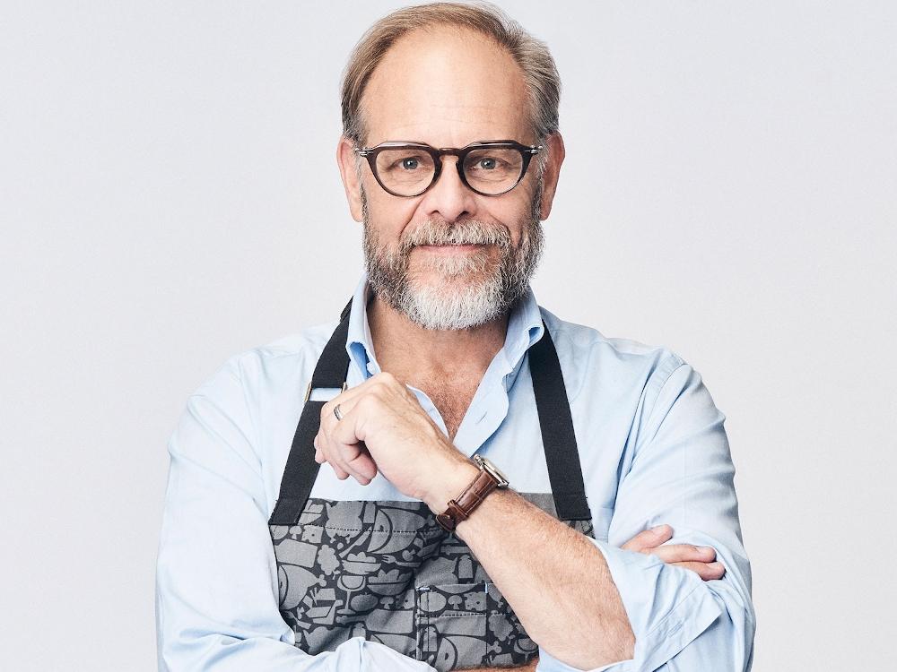 Smiling man with glasses and apron
