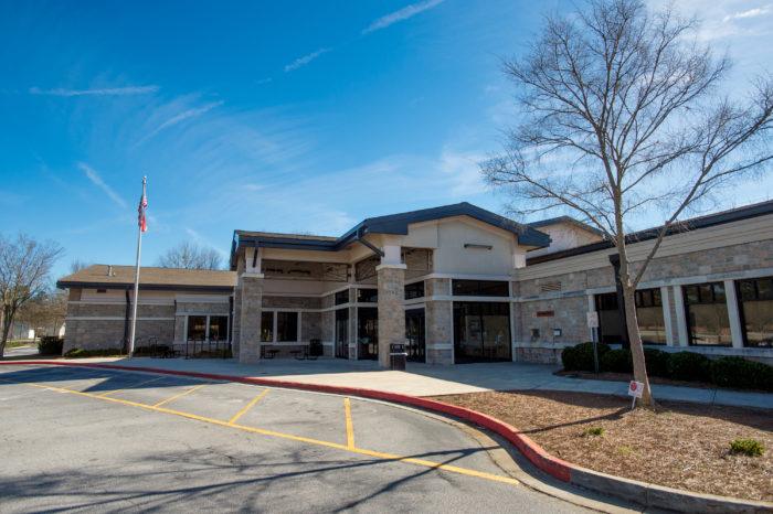 grayson branch exterior Brick building under blue sky with flagpole.
