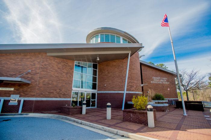 hamilton mill branch exterior Modern building with round entrance and flagpole.