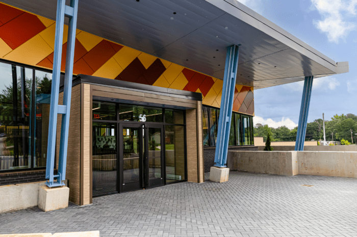 hooper renwick branch exterior Colorful modern building entrance with glass doors.