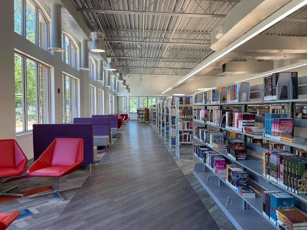 inside gwinnett library finding a book Modern library with bookshelves and reading chairs.