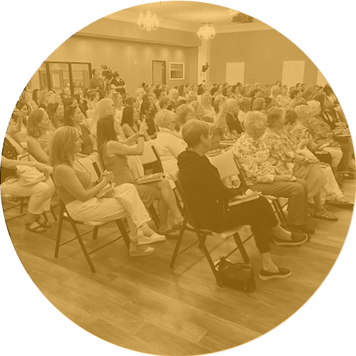 Event audience seated and attentive in conference room.