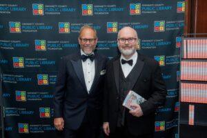 Two men in tuxedos at library foundation event